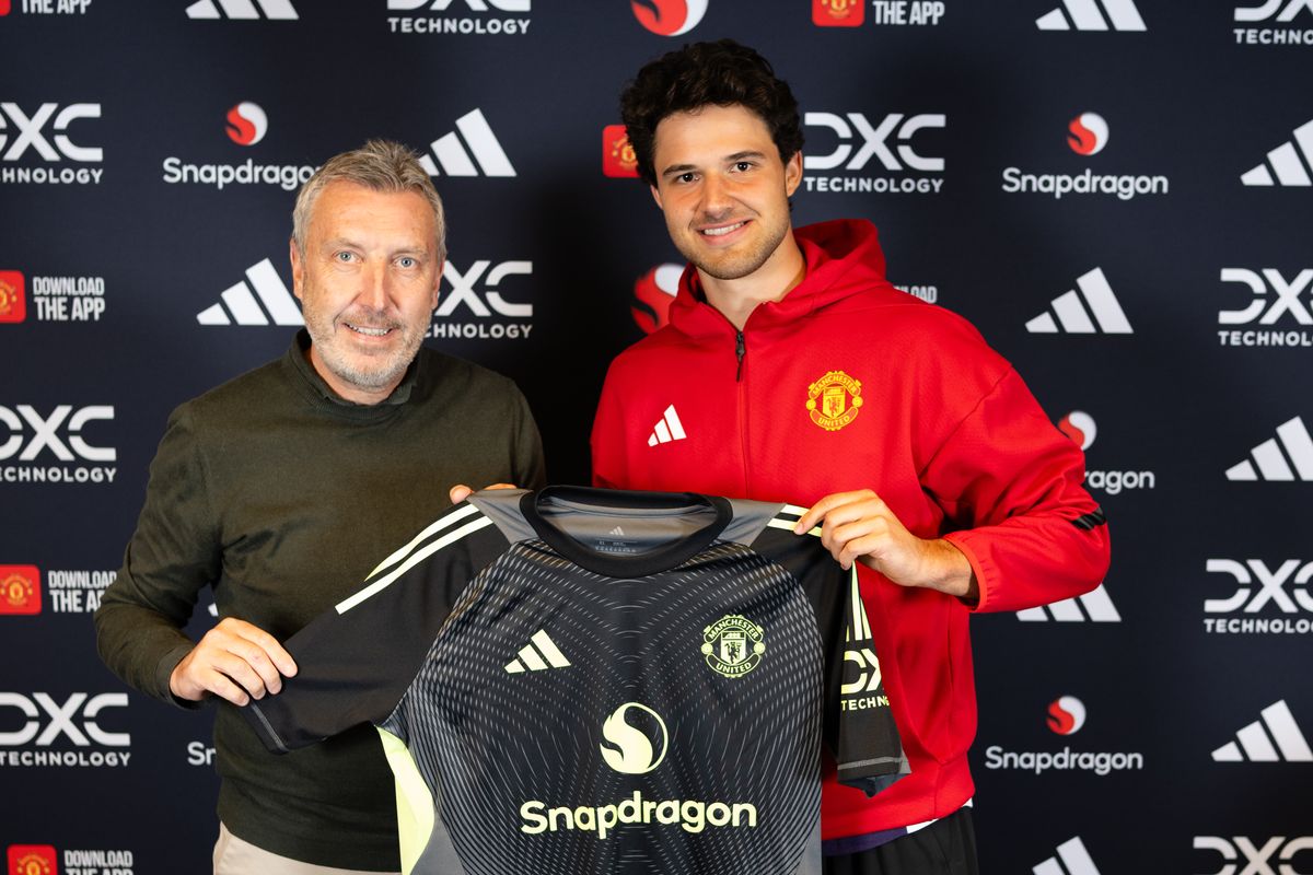 Senne Lammens of Manchester United poses with Director of Football Jason Wilcox after signing for the club at Carrington Training Ground on September 01, 2025 in Manchester, England