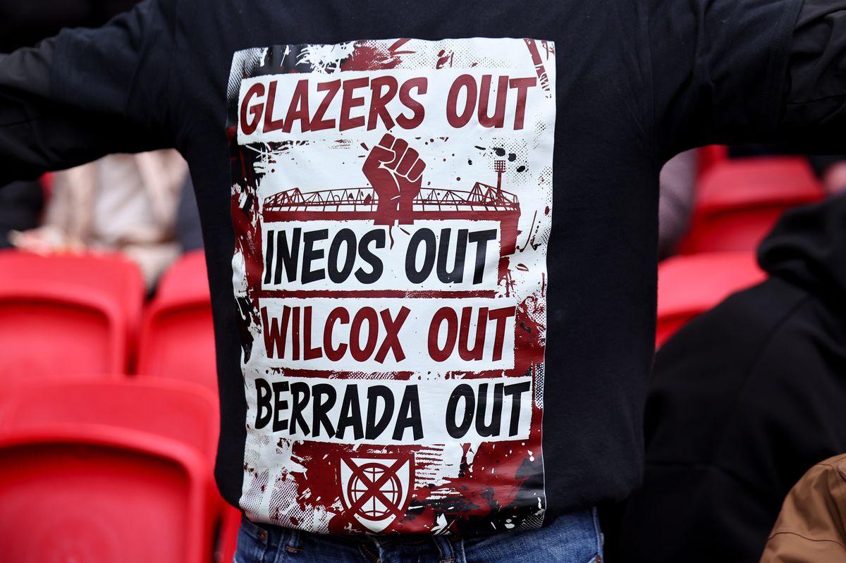 A fan of Manchester United wearing a jumper protesting against the clubs ownership, The Glazer Family, Ineos - Jim Ratcliffe, Director of football, Jason Wilcox and CEO, Omar Berrada ahead of the Premier League match between Manchester United and Fulham at Old Trafford on February 1, 2026 in Manchester, United Kingdom