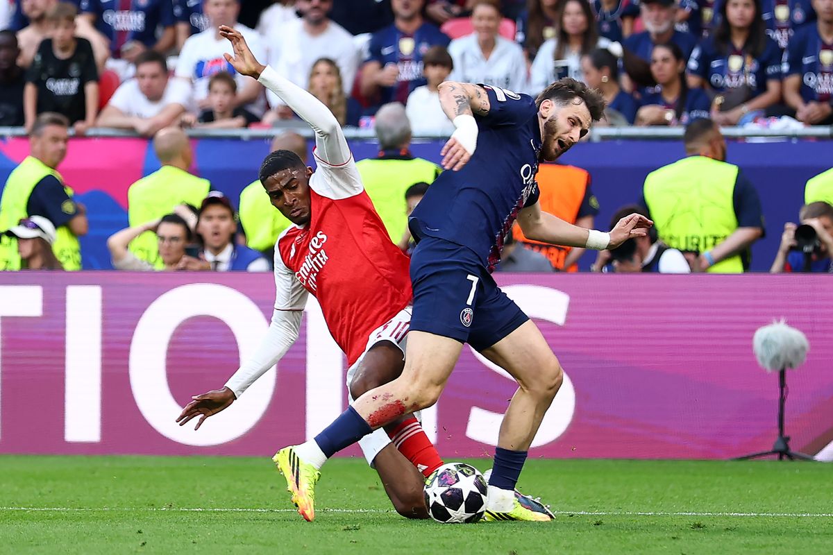 Cristhian Mosquera of Arsenal fouls Khvicha Kvaratskhelia of Paris Saint-Germain in the box to concede a penalty during the UEFA Champions League Final