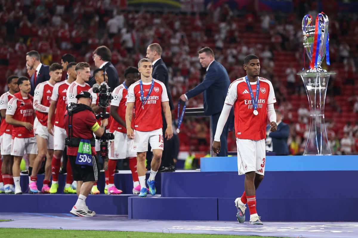 Cristhian Mosquera of Arsenal walks past the UEFA Champions League trophy