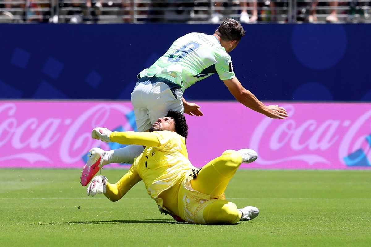 Remo Freuler #8 of Switzerland collides with Mahmoud Abunada #1 of Qatar during the FIFA World Cup 2026 Group B match between Qatar and Switzerland at San Francisco Bay Area Stadium on June 13, 2026 in Santa Clara, California. Switzerland was awarded a penalty on the play