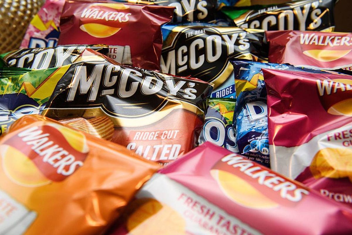 A selection of crisps and snacks are seen on a newsagent shelf in London