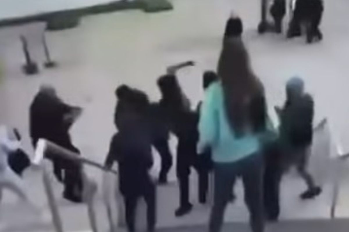 A video still of a teenager appearing to pull out a machete as part of youth brawl on the Chavasse Park steps in Liverpool city centre
