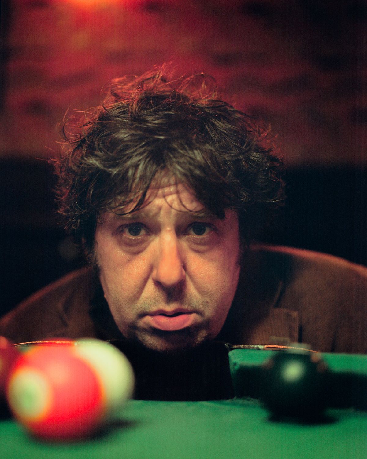 close-up of Jim E Brow's face behind a pool table