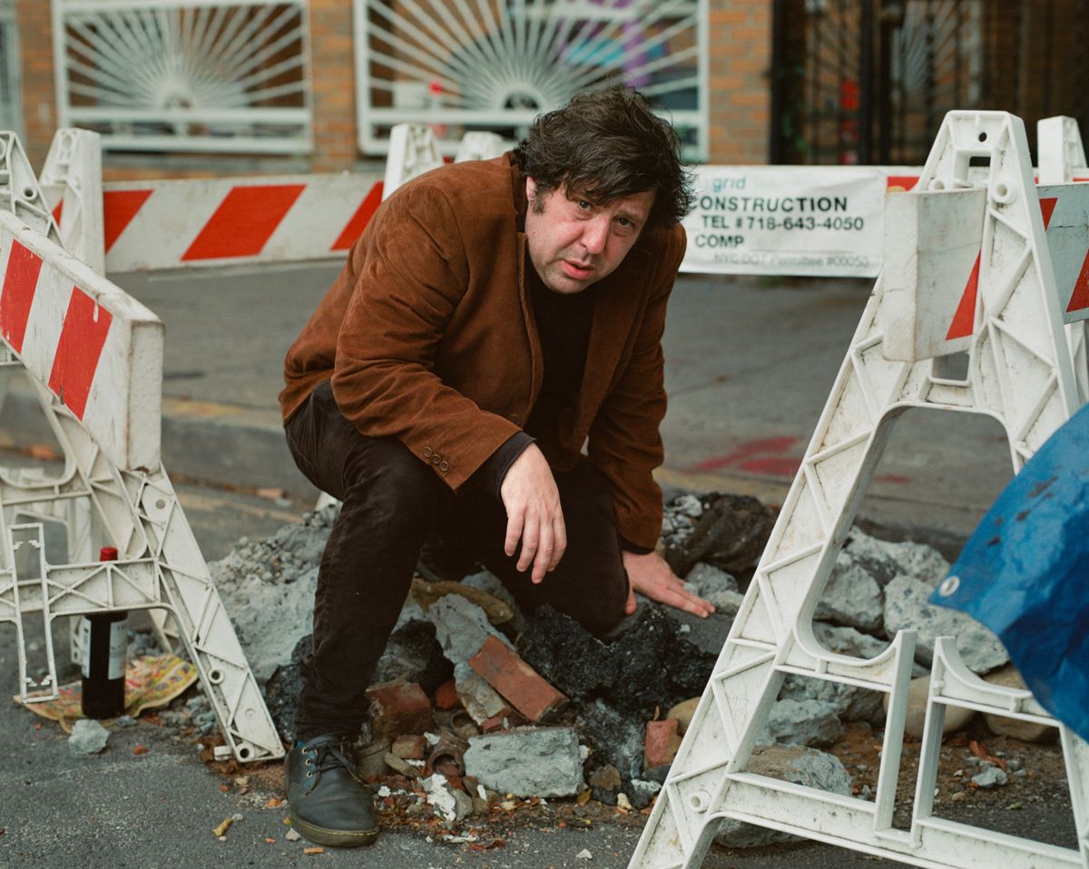Jim E Brown kneeling over a construction site