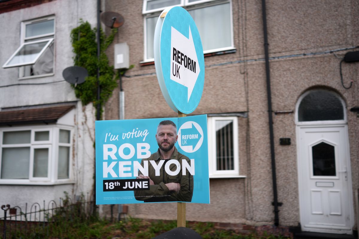 A Reform UK placard of their by-election candidate Robert Kenyon stands outside a home