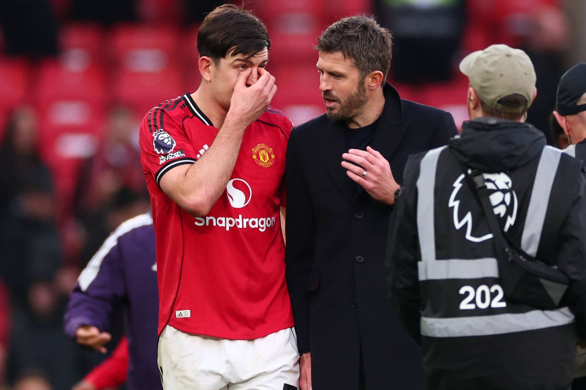 Michael Carrick speaks with Harry Maguire