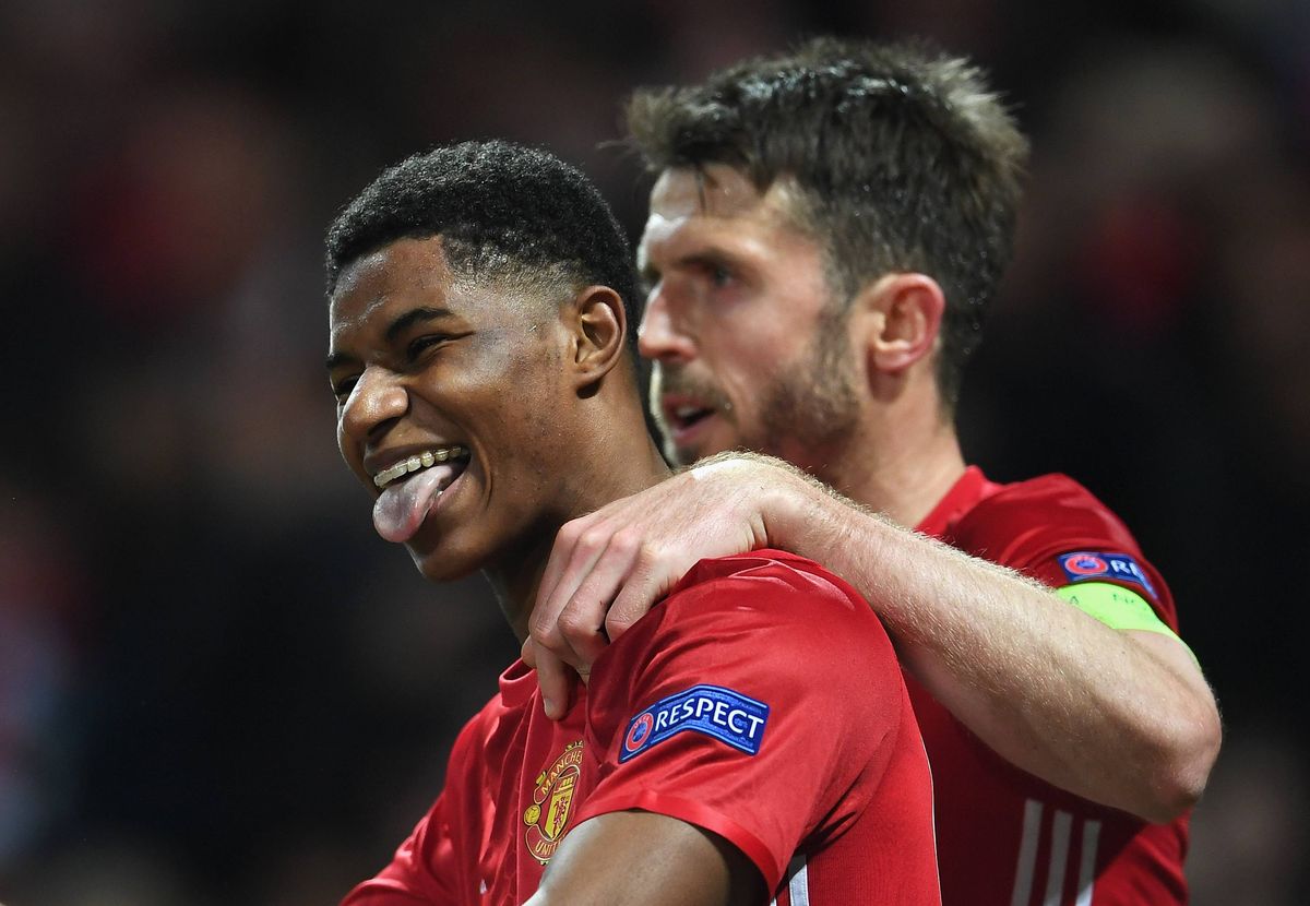 Marcus Rashford of Manchester United celebrates with team mate Michael Carrick as he scores their second goal during the UEFA Europa League quarter final second leg match between Manchester United and RSC Anderlecht at Old Trafford