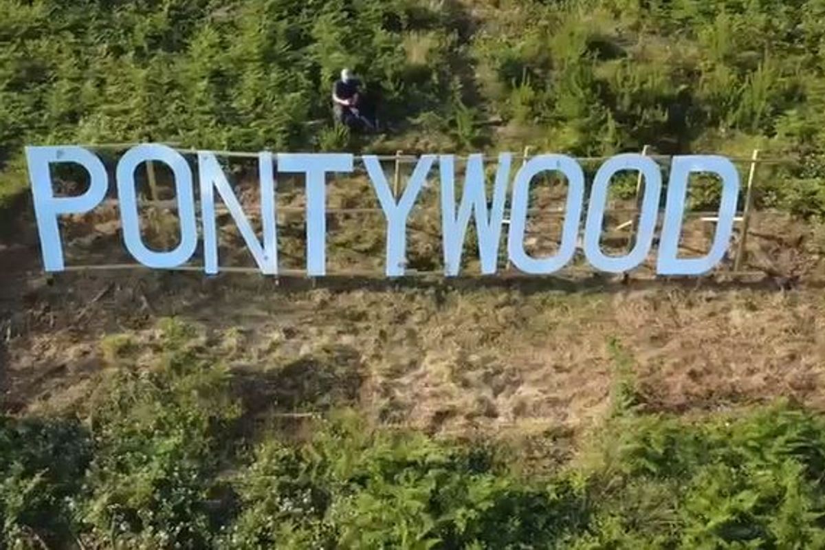 A sign on a hill