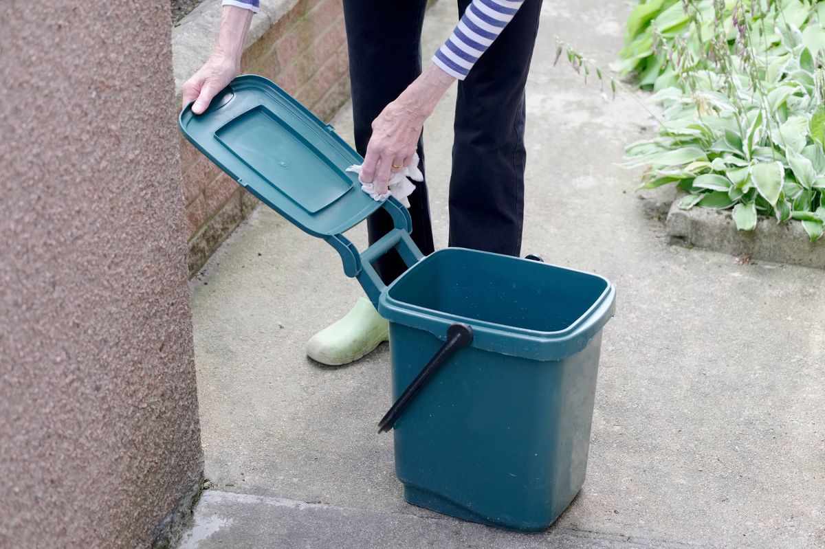 Recycle food green bin being clean to help environment conservation England UK