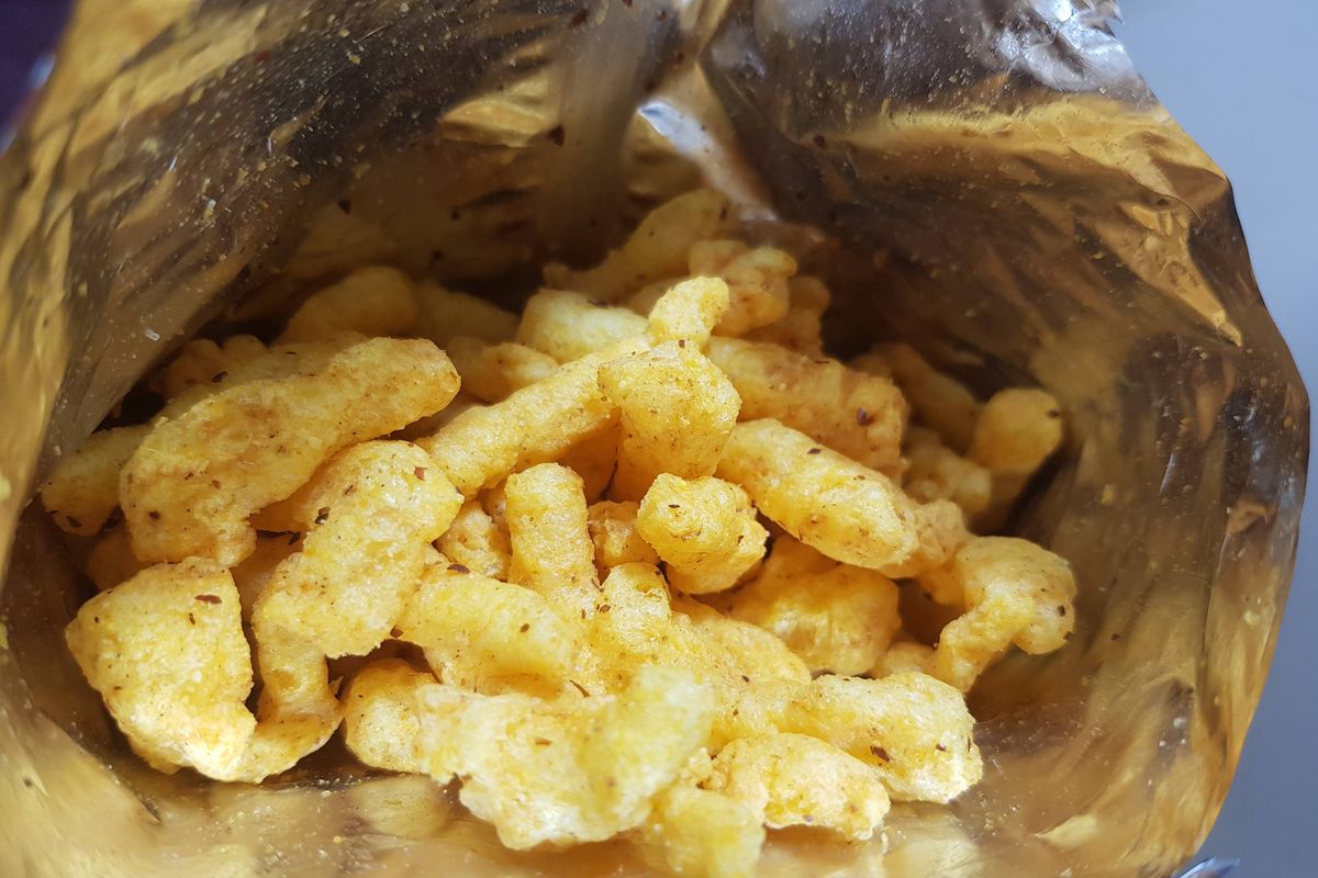 Crispy fried potato sticks inside the package. The concept of unhealthy diet and lifestyle, accumulation of excess weight.