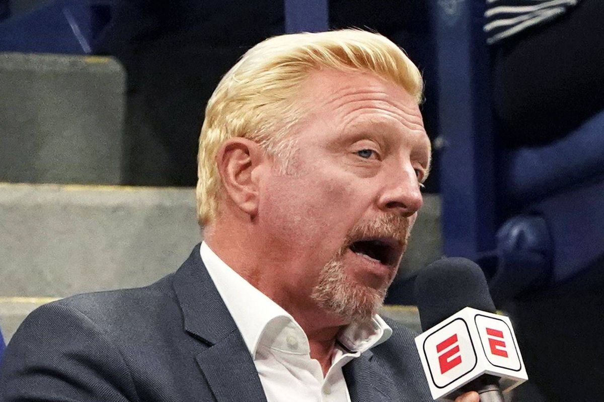 Former tennis player Boris Becker of Germany (C) is interviewed by a journalist as he watches the 2017 US Open Men's Singles match between Germany's Mischa Zverev and John Isner of the US, at the USTA Billie Jean King National Tennis Center