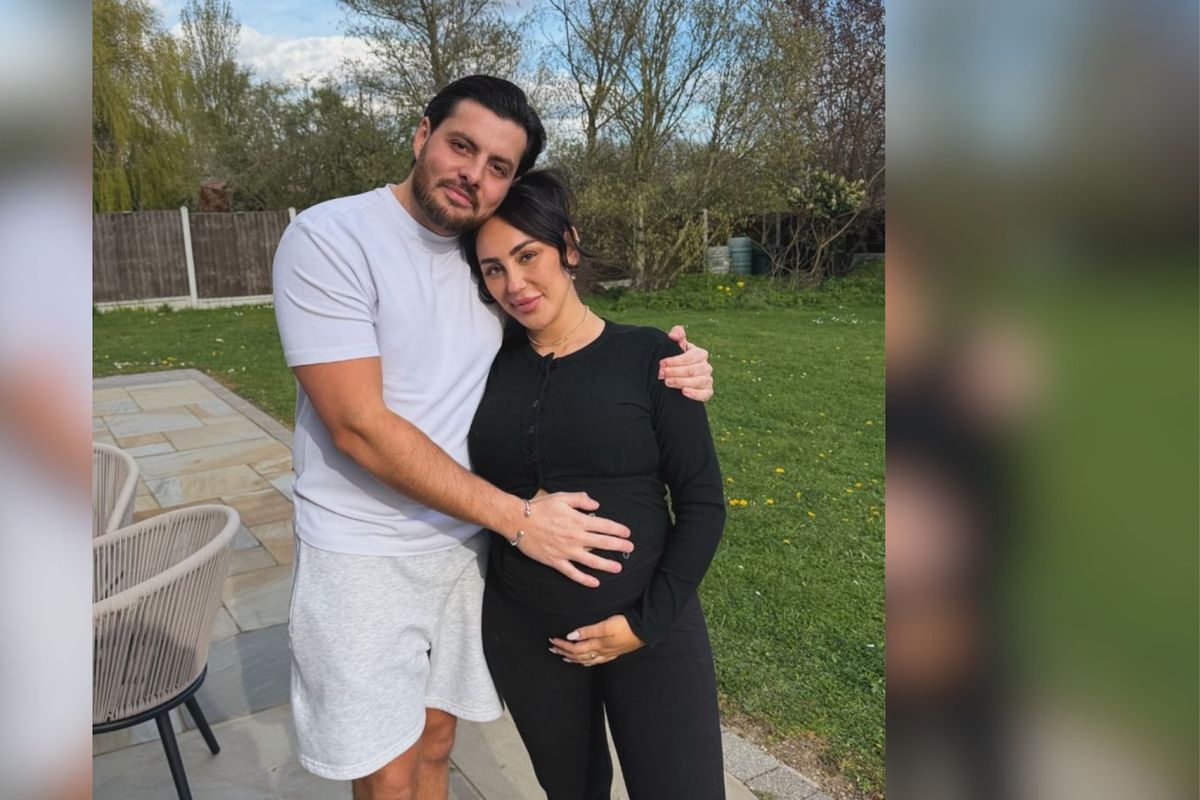 Sophie Kasaei and Jordan Brook pose with her baby bump