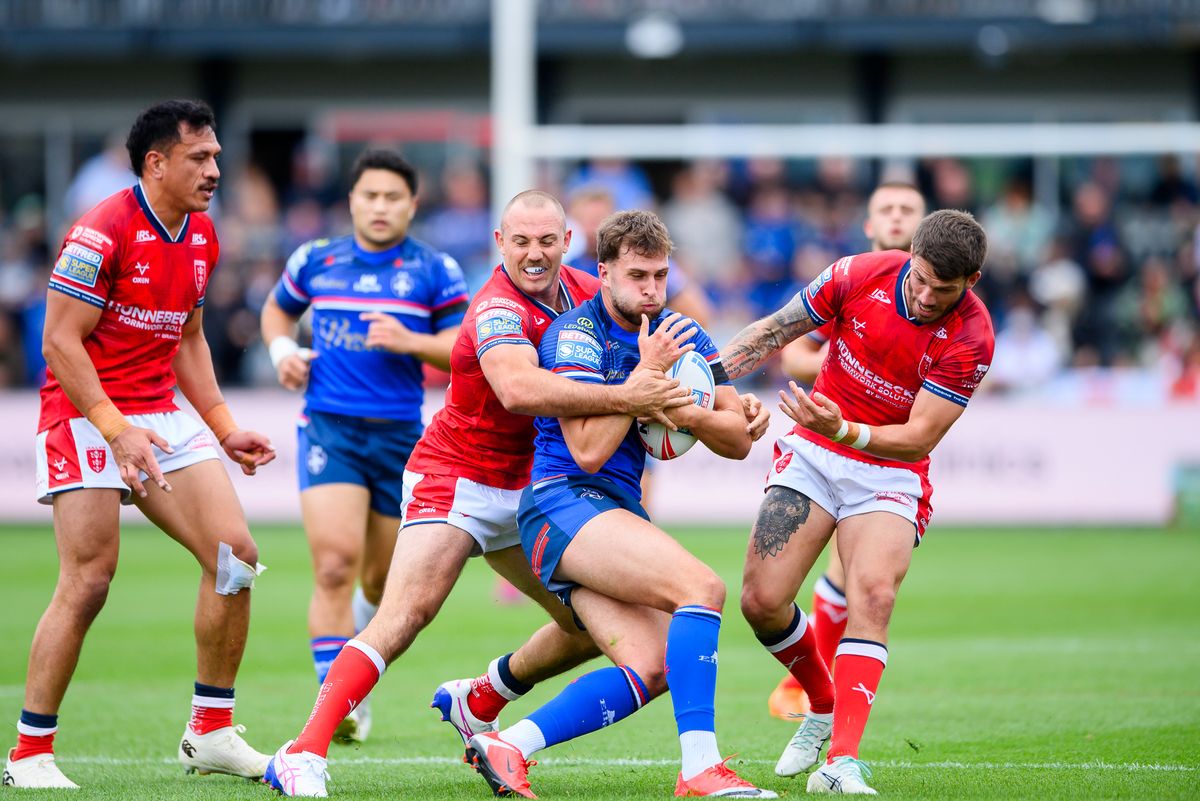 Wakefield's Josh Rourke is tackled by Hull KR's Karl Lawton and Oliver Gildart.