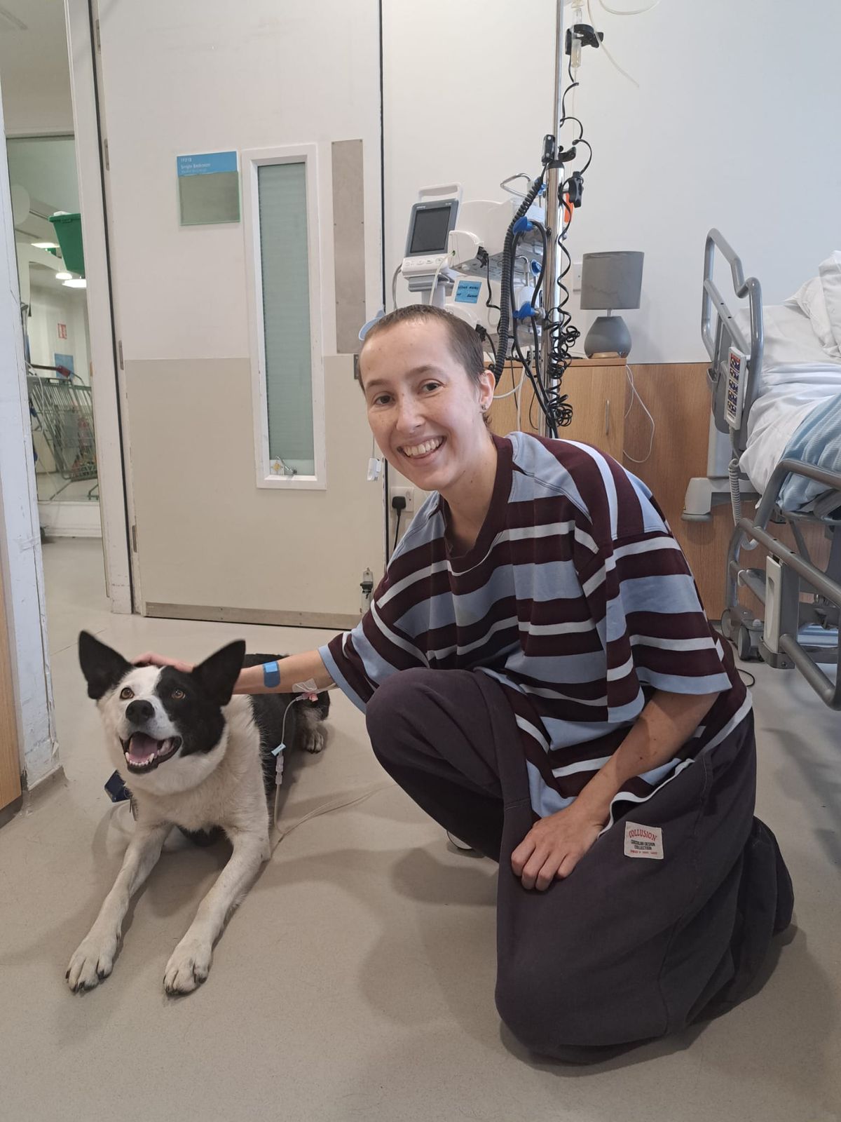 Caitlin in hospital with a dog