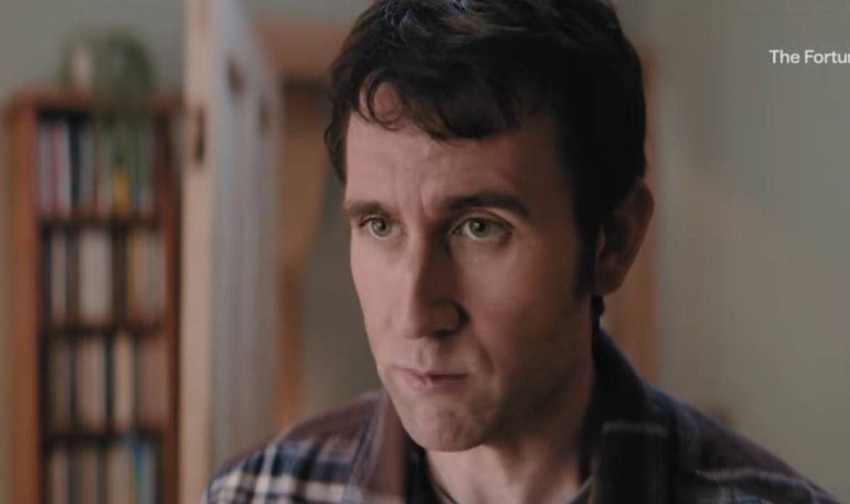 Clean shaven man in checkered shirt