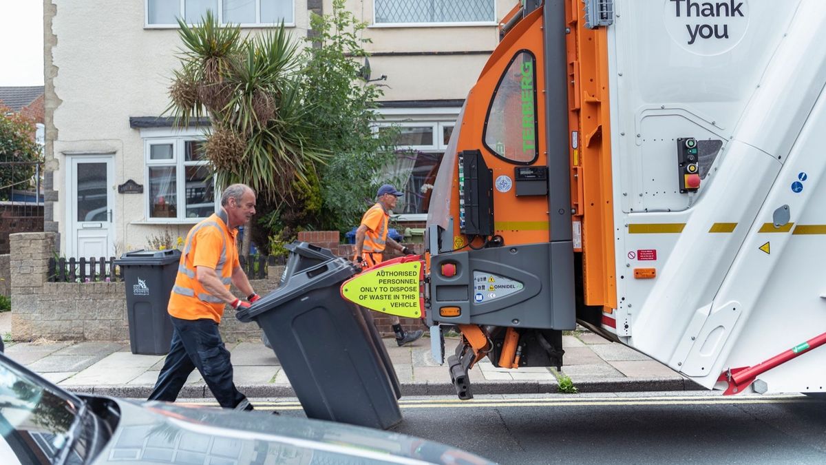 A recycling crew emptying bins in Cleethorpes in earlier this year - extra hours shifts are being worked by crews to get through the backlog on grey bins