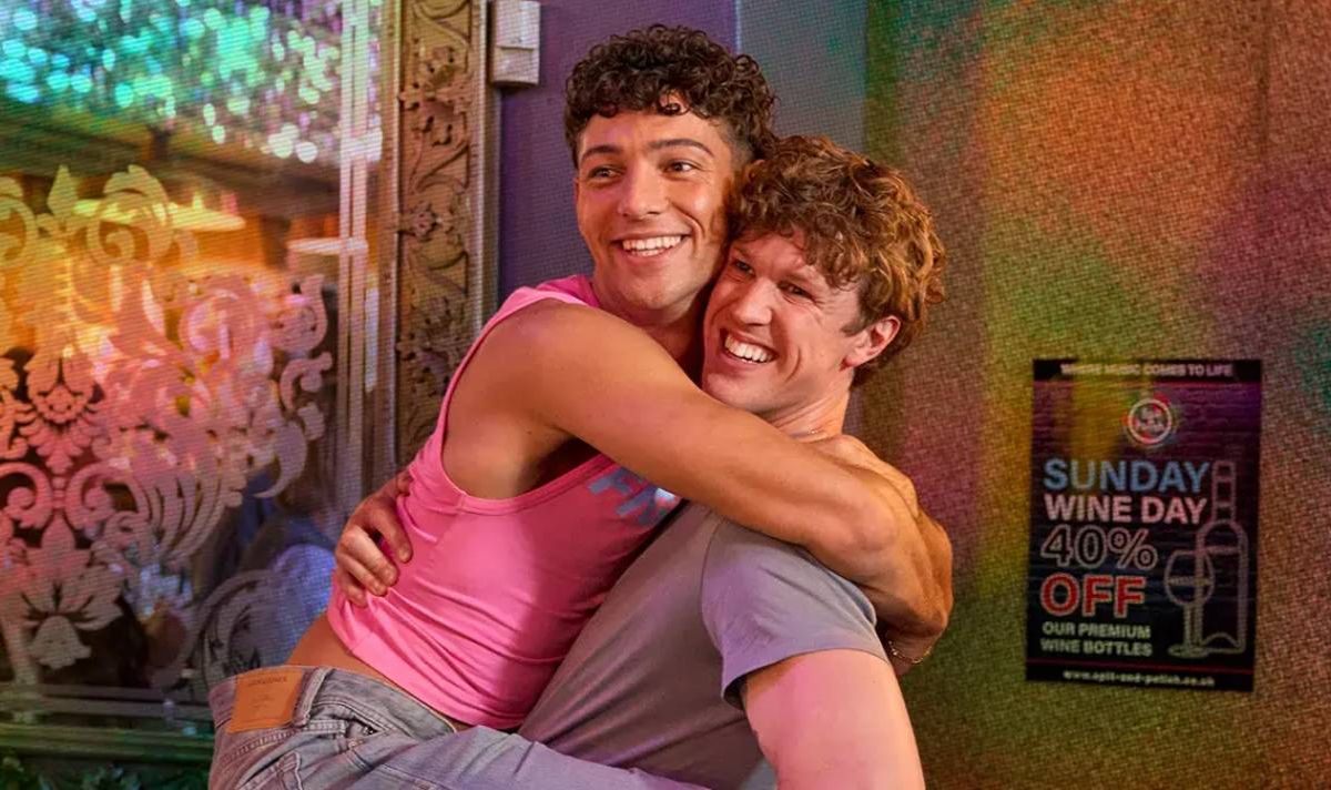 Two men smiling and hugging