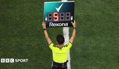 The fourth official holds up the substitution board during the Fifa World Cup match between Iran and New Zealand