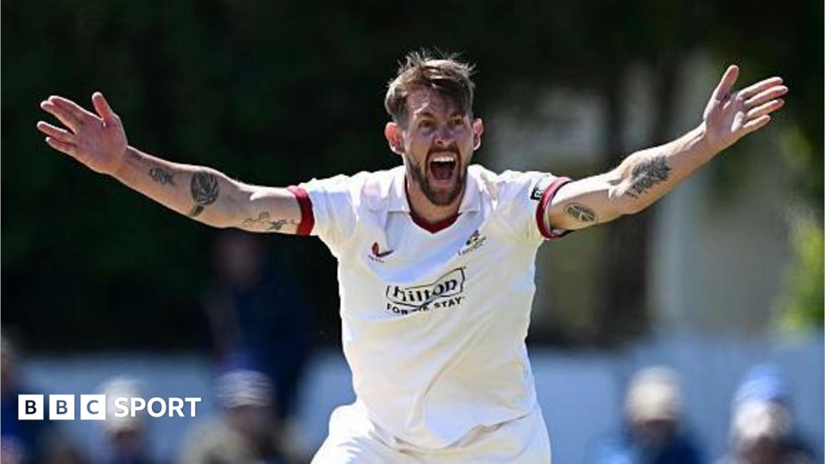 Playing in a Championship game, Tom Bailey has both arms outstretched appealing for a wicket towards the umpire