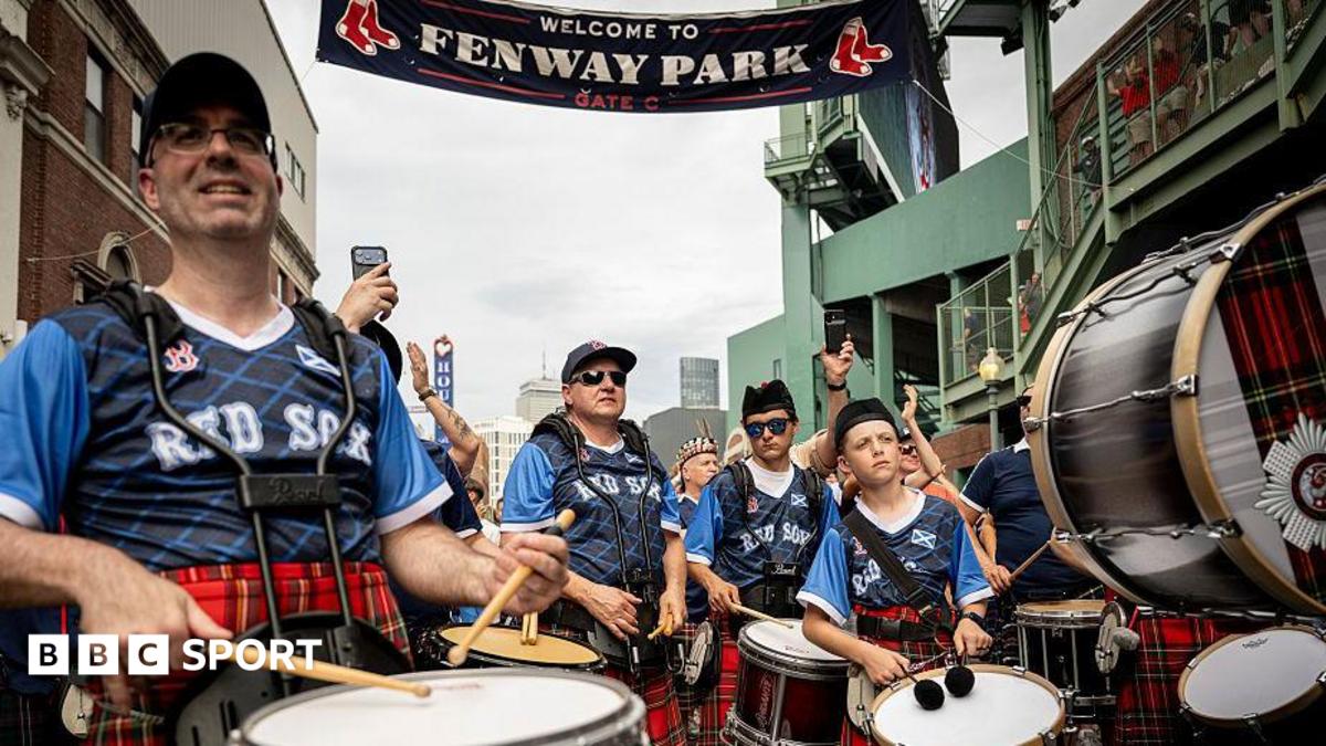 A pipe band outside Fenway Park wearing tartan tops bearing the words "Rex Sox"