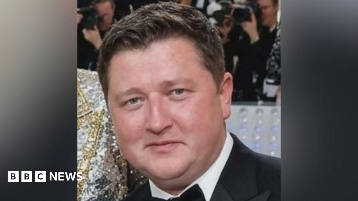 Daniel Vettrino looking straight at the camera. He has short, dark hair. He is wearing a black suit over a white shirt with a bow tie. Only his head and neck are visible.