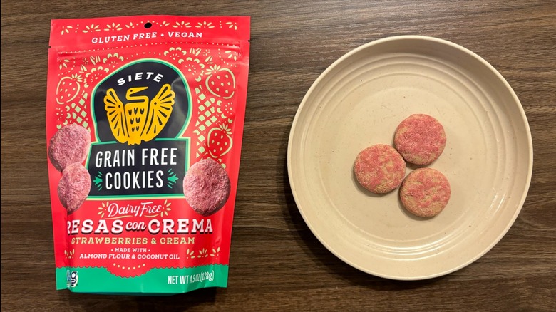 Siete Strawberries and Cream Grain-Free Cookies bag with strawberry gluten free cookies on brown plate