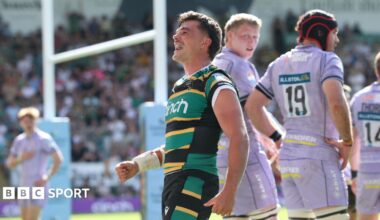 George Furbank, wearing his green, black and yellow striped Northampton Saints kit, celebrates his try against Gloucester in May