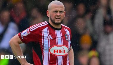Pierce Sweeney in action for Exeter City in their red and white striped home shirt