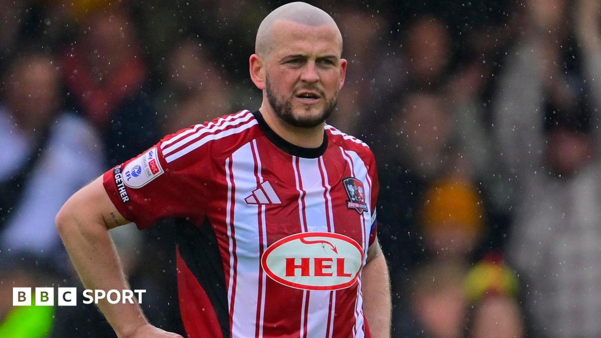 Pierce Sweeney in action for Exeter City in their red and white striped home shirt