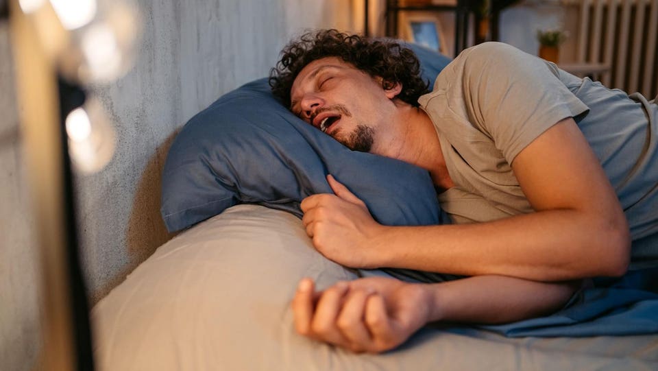 Young Man Snoring In The Bed At Night