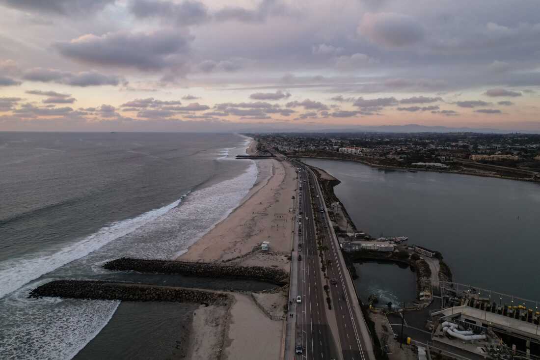 A drone view from 2025 shows the Carlsbad desalination plant's intake lagoon on the right and the discharge canal on the left in Carlsbad, Calif.