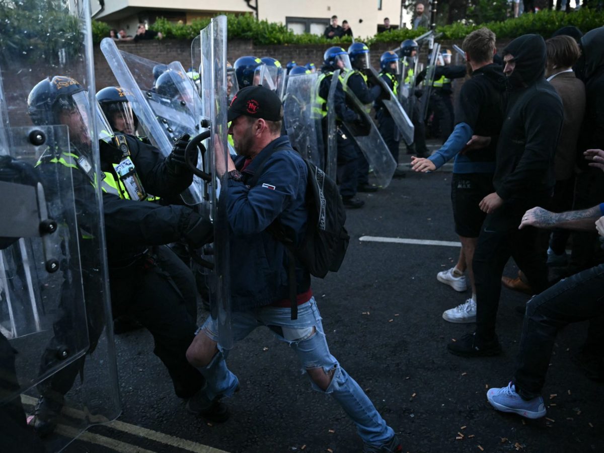 Demonstrators push against a police line near Portswood Police Station, following a protest march in Southampton, southern England, on June 2, 2026, held in reaction to the Police's handling of the detention of victim Henry Nowak, following the conviction of his murderer Vickrum Digwa. Body camera footage of dying student Henry Nowak, who was handcuffed by British police after being stabbed by Sikh man Vickrum Digwa, and falsely accused of racially abusing his murderer sparked outrage Tuesday. (Photo by JUSTIN TALLIS / AFP via Getty Images)