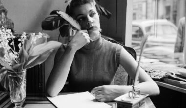 Writer working diligently at a desk, surrounded by notes and a laptop, focused on creating content for a news article.