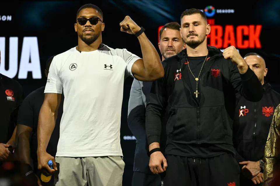 Anthony Joshua and Kristian Prenga on stage at a press conference