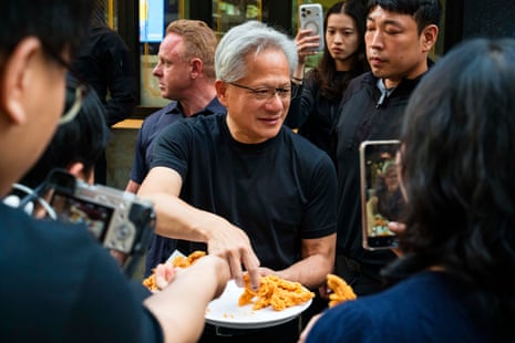 Nvidia founder and CEO Jensen Huang hands out fried chicken to members of the media as he eats and drinks beer with SK Group chairman Chey Tae-won at Kkanbu Chicken.
