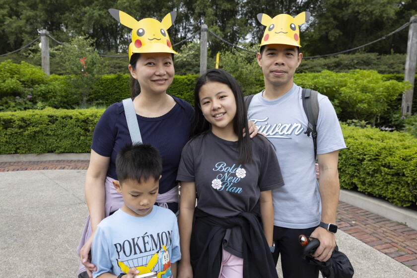Shirley and Steve Tan and their children Steven, 7, and Stephanie, 10, take part in Friday's Pokémon Go Fest in Grant Park.