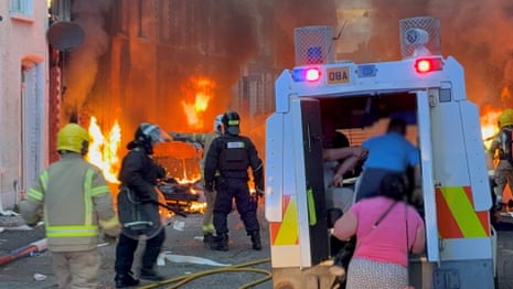 Belfast residents run from burning homes as violence erupts after protests – video
