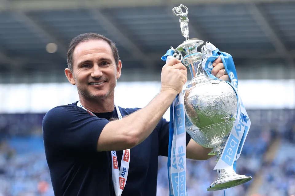 Coventry City manager Frank Lampard holds the championship trophy aloft after the Sky Bet Championship match between Coventry City and Wrexham AFC