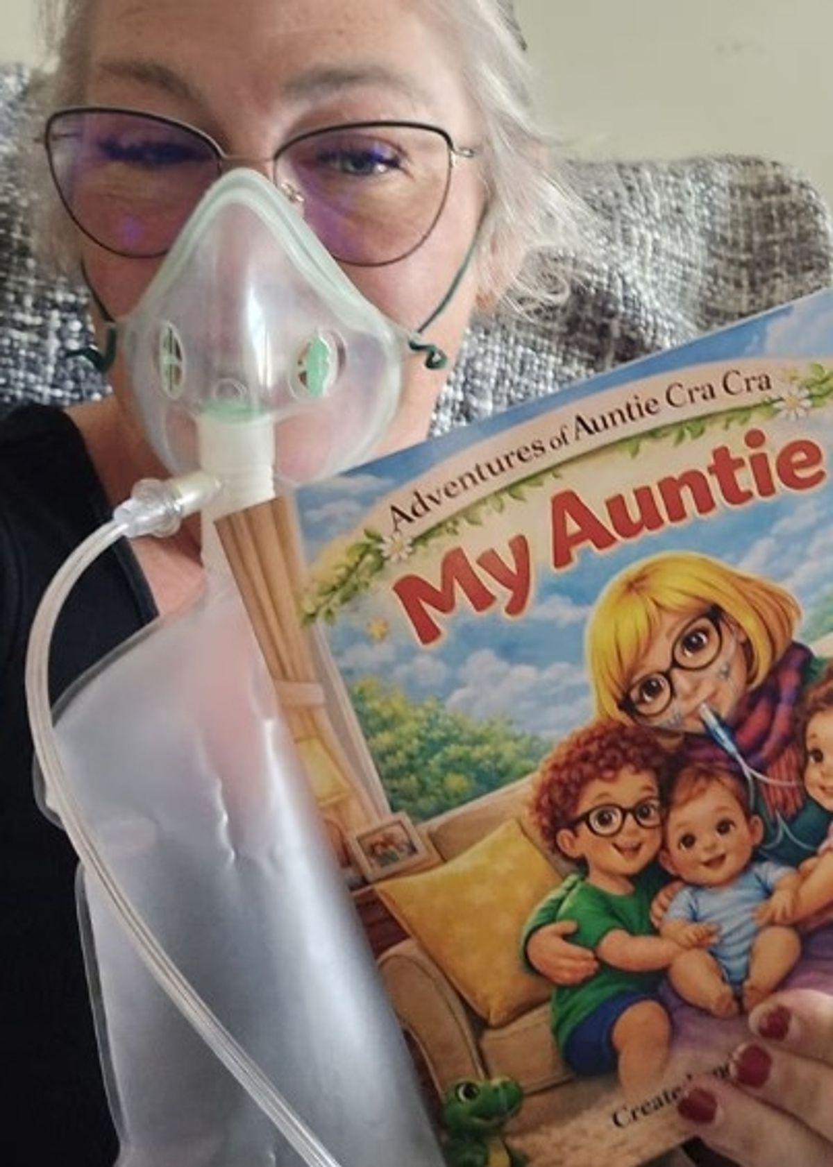 Clare pictured holding her book which she wrote based on her experiences