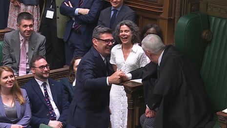 Andy Burnham sworn in as MP as Commons erupts in cheers and heckles – video