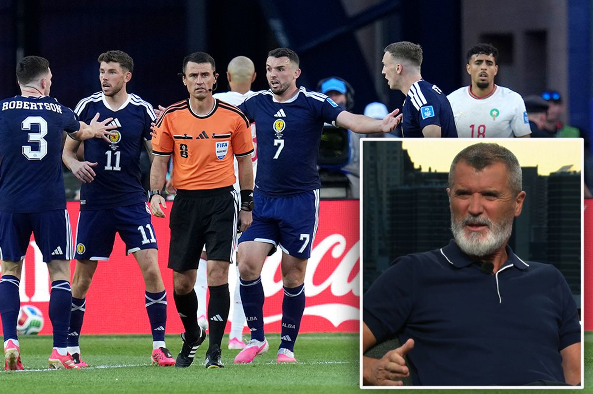 Scotland players surround referee Ilgiz Tantashev (centre) after John McGinn (centre right) went down in the penalty area