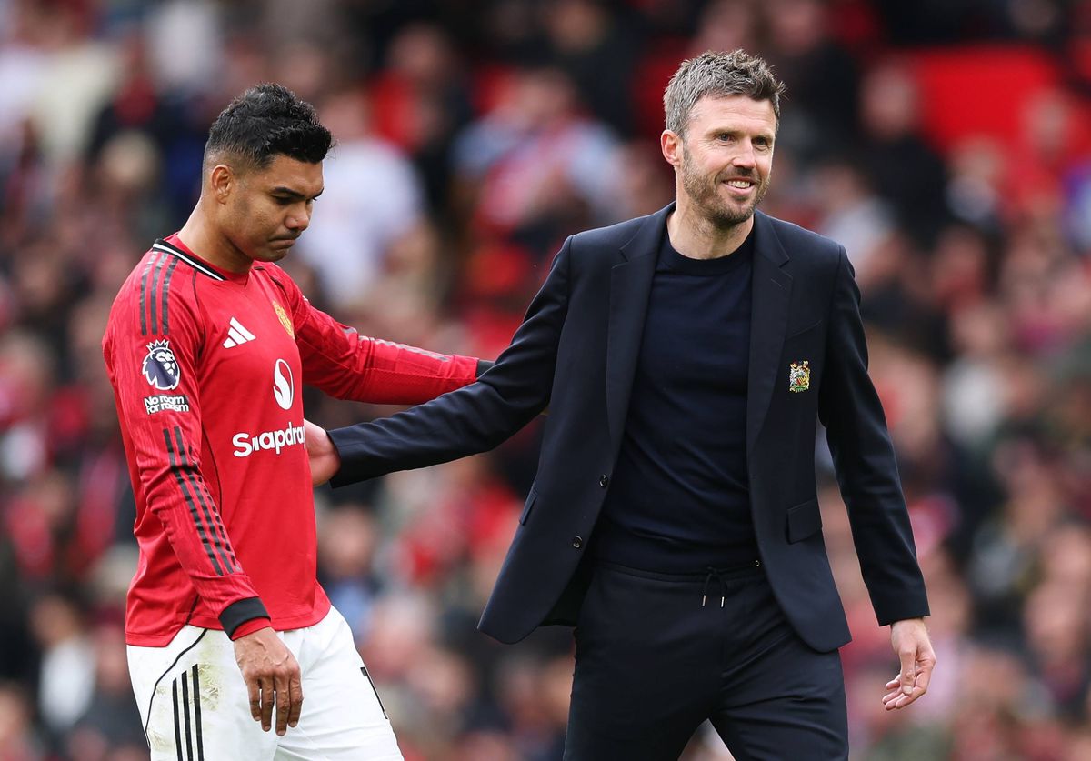 Michael Carrick, Manager of Manchester United, embraces Casemiro