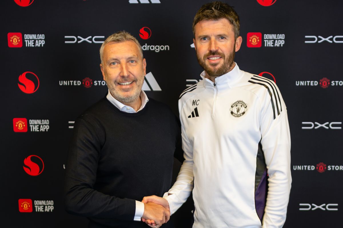 Head Coach Michael Carrick of Manchester United poses with Director of Football Jason Wilcox after signing a contract to remain as Head Coach at Carrington Training Ground on May 22, 2026 in Manchester, England