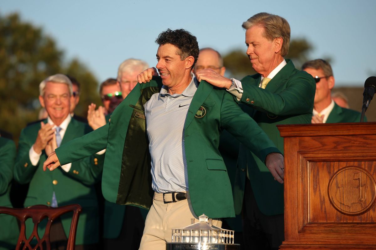 Fred Ridley, chairman of Augusta National Golf Club, awards Rory McIlroy of Northern Ireland with the Green Jacket during the Green Jacket Ceremony after the final round of the 2026 Masters Tournament at Augusta National Golf Club