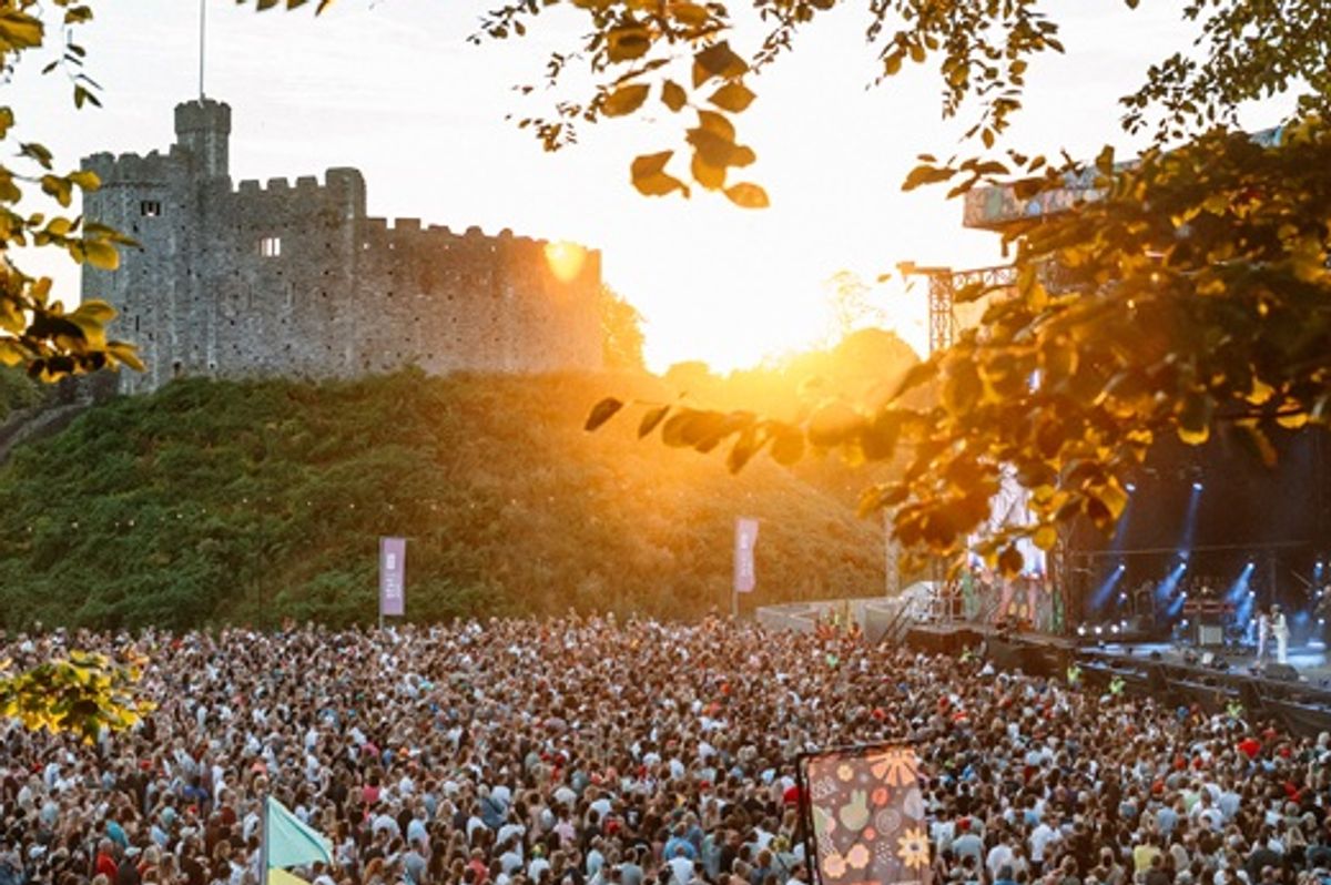 Concert goers at Cardiff Castle as the sun goes down