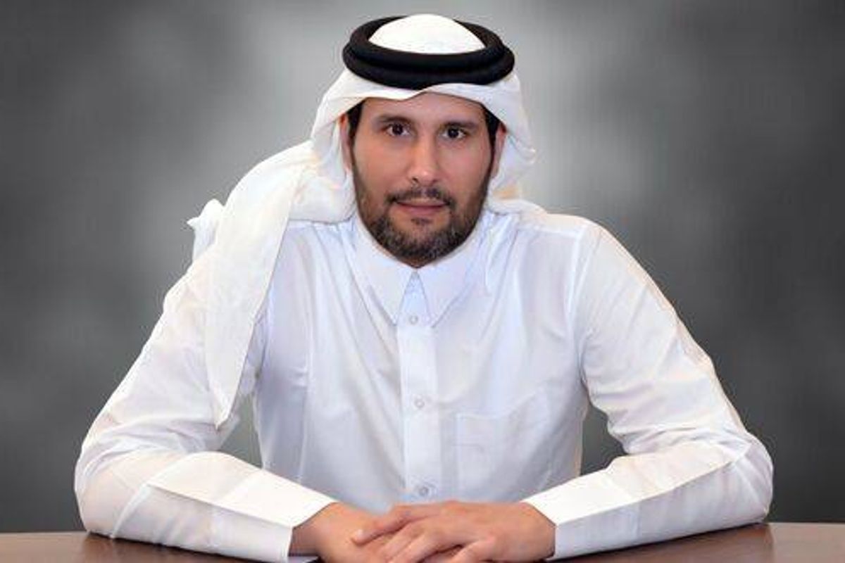 Sheikh Jassim sitting at a table