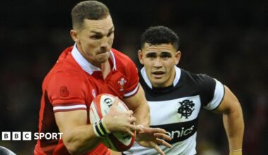 George North in the red jersey of Wales runs with the ball against the Barbarians