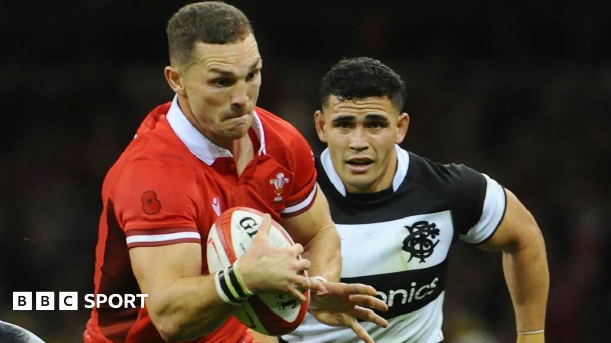 George North in the red jersey of Wales runs with the ball against the Barbarians