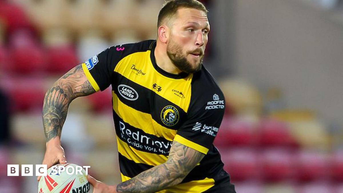 York Knights player Josh Griffin, in yellow and black, about to pass the ball